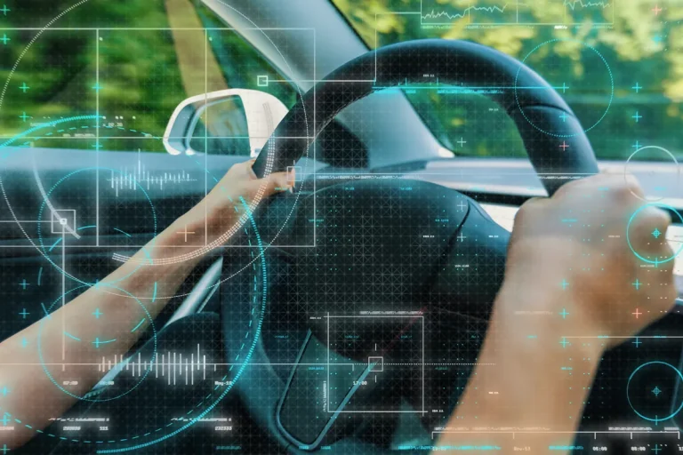 Close up to hands on the wheel. Concept of machine learning applied to automotive industry.